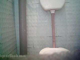 Beauty in blue pants is pissing in the toilet and wiping her shaved pussy in the voyeur toilet