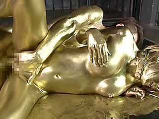 Japanese chick covered in gold has a blast riding a big boner